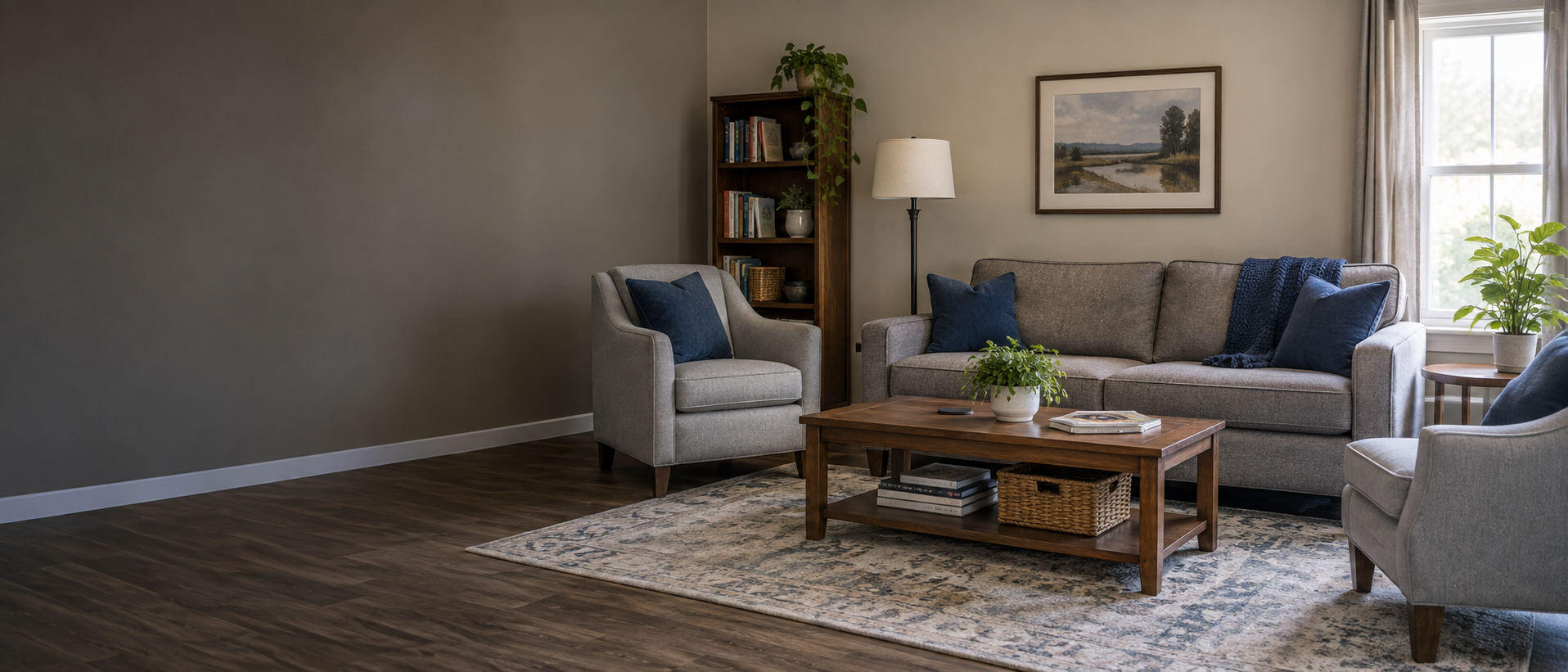 A clean, welcoming shared living room with navy accents and natural light